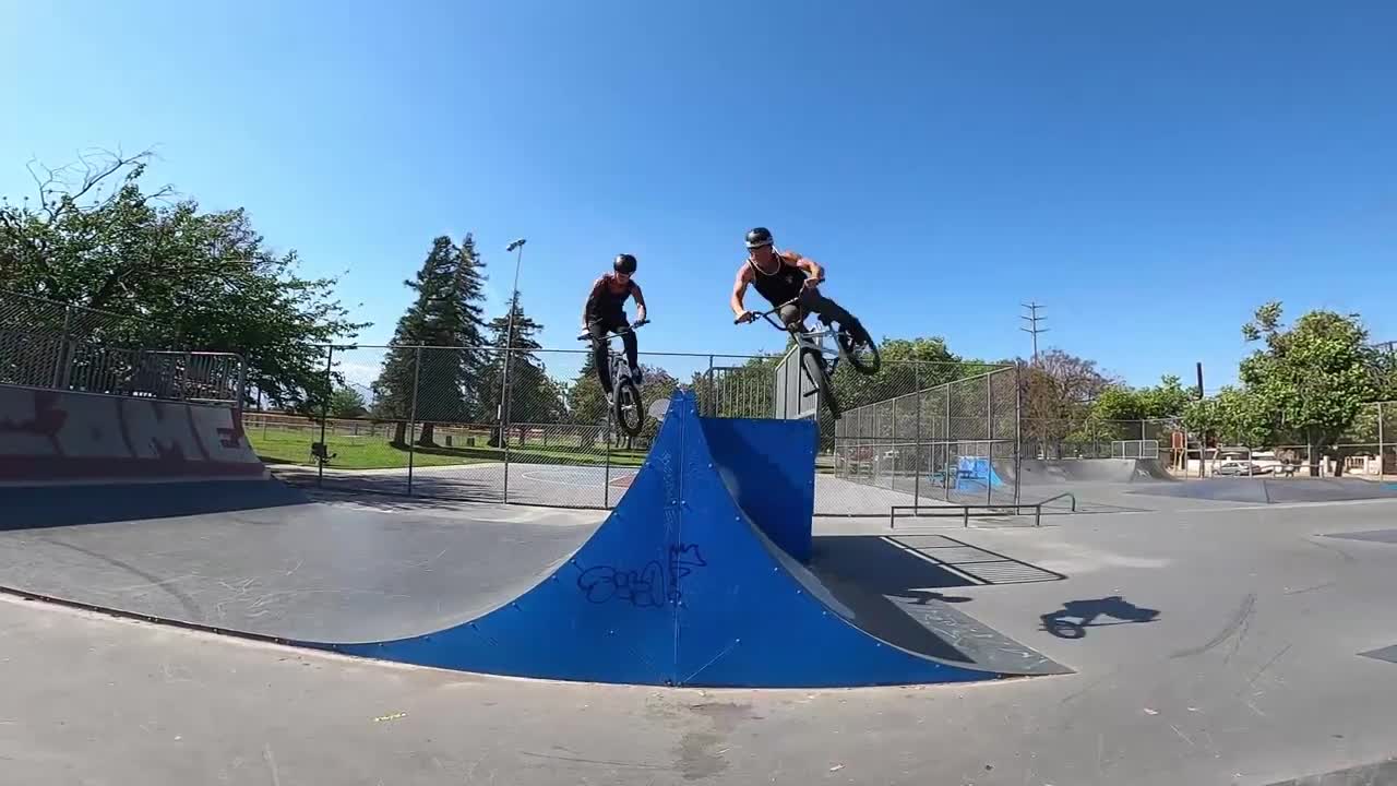 Guys Do A Duo Backflip Jump On Bmx Ramp