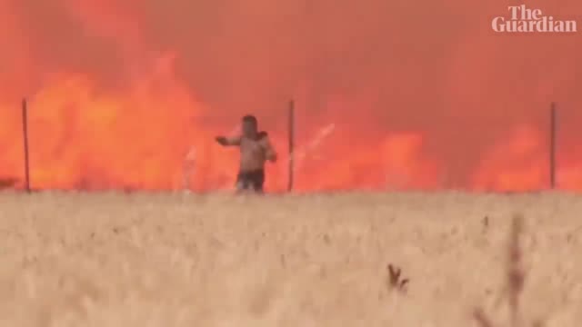 Spain: man caught in wildfire escapes with clothes ablaze