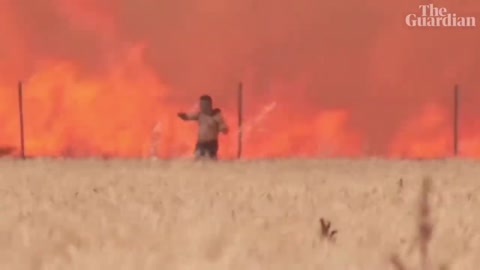 Spain: man caught in wildfire escapes with clothes ablaze