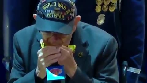 96-year-old World War II veteran Pete DuPré plays the national anthem on his harmonica.
