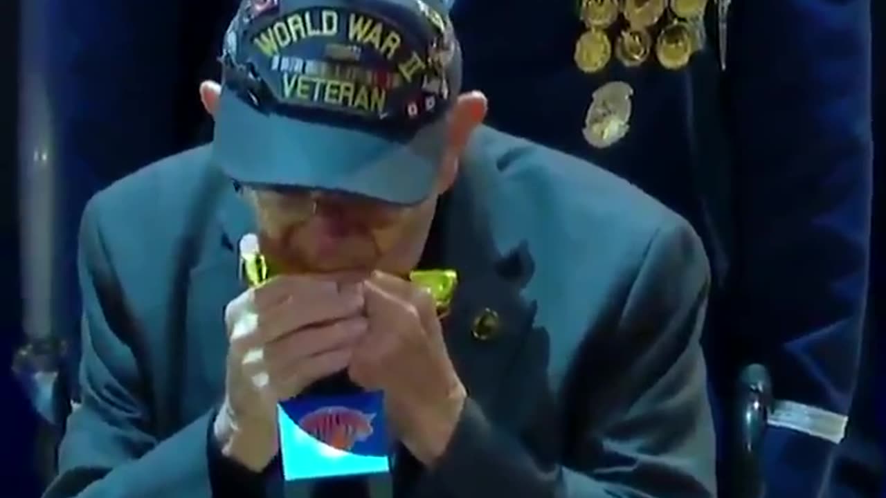 96-year-old World War II veteran Pete DuPré plays the national anthem on his harmonica.