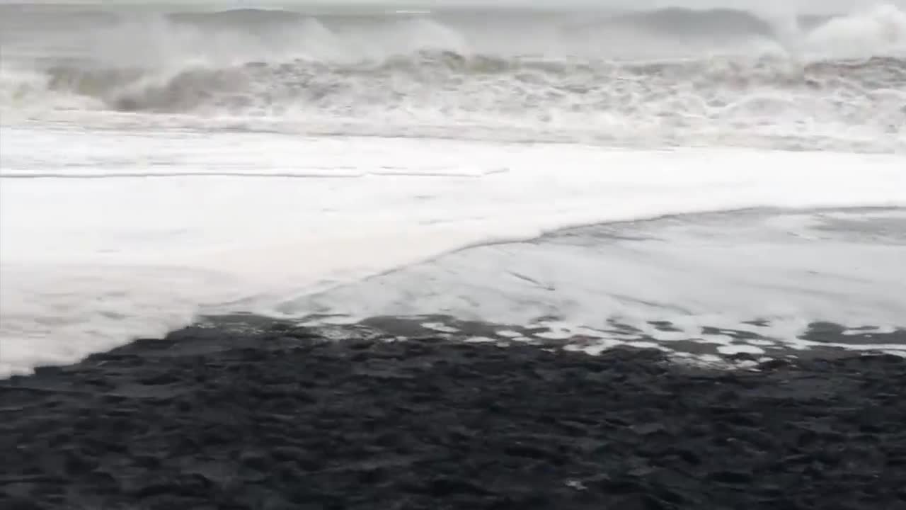 Waves Sneak Up Reynisfjara Beach in Iceland and Knock Over Tourists