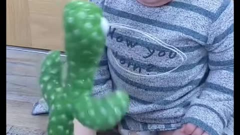 Cute baby playing with plant