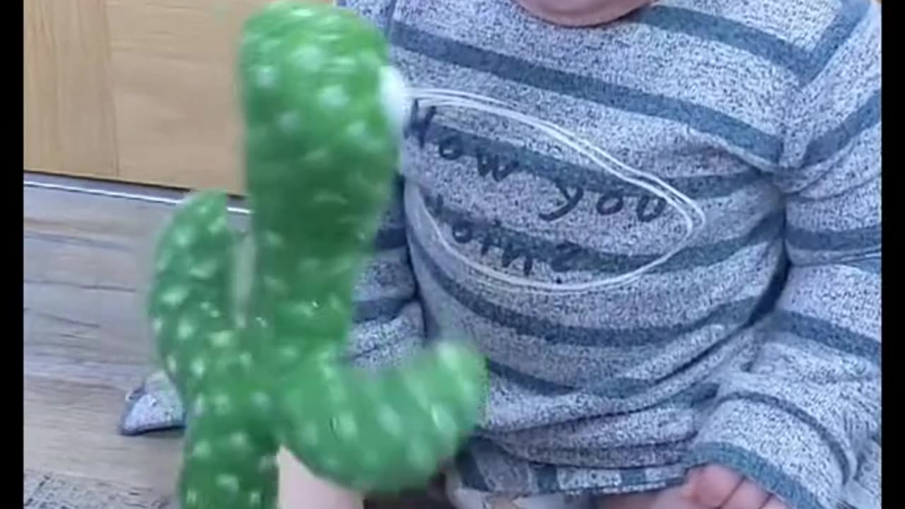 Cute baby playing with plant