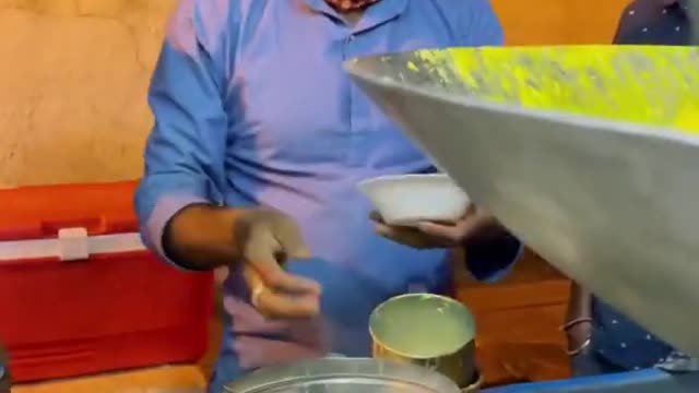 Man Cooks And Serves Local Dessert Item With Hot Cashew Milk