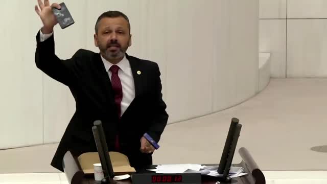 Turkish lawmaker smashes phone with hammer in parliament to protest social media bill