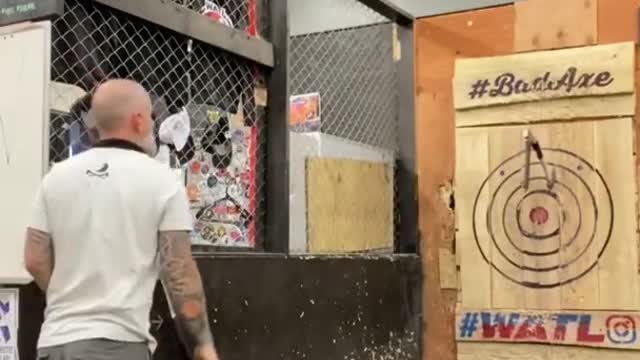 Man Strikes One Ax With Another