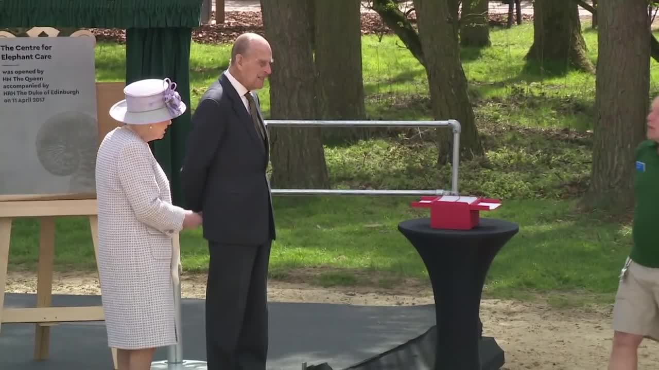 Queen and Duke of Edinburgh feed elephants bananas