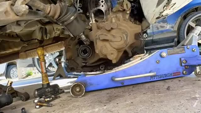 Repairman disassemble automobile gearbox.