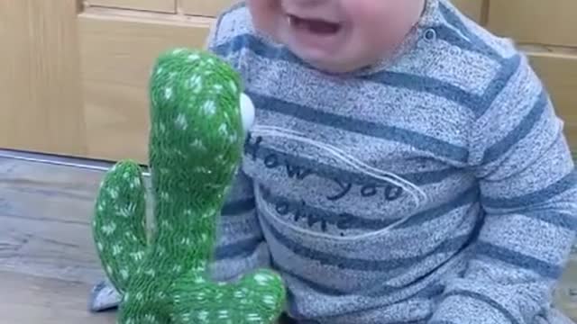 baby's funny moment seeing moving toys