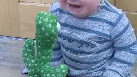 baby's funny moment seeing moving toys