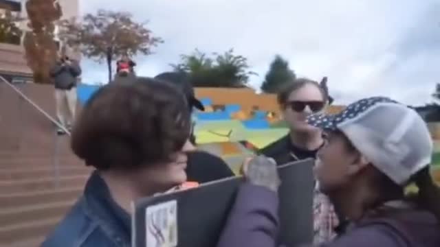 Trans protester tries to spit on feminist girl but she luckily bodies it