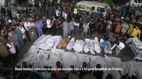 Now playing Bodies line up outside Gaza hospital as Israeli airstrikes continue