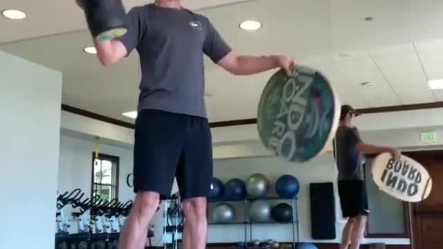 Man Displays Impressive Basketball Dribbling Skills While Balancing On Wooden Board