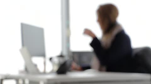 foggy view of a woman playing on a laptop