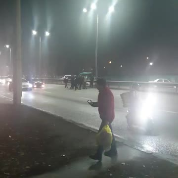 A large column of demonstrators is moving along Sain Street in Almaty