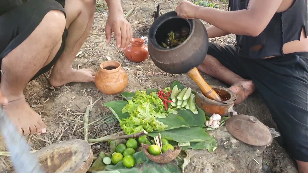 Primitive cooking in the forest yummy snail with hot chilies source inside pot traditional,