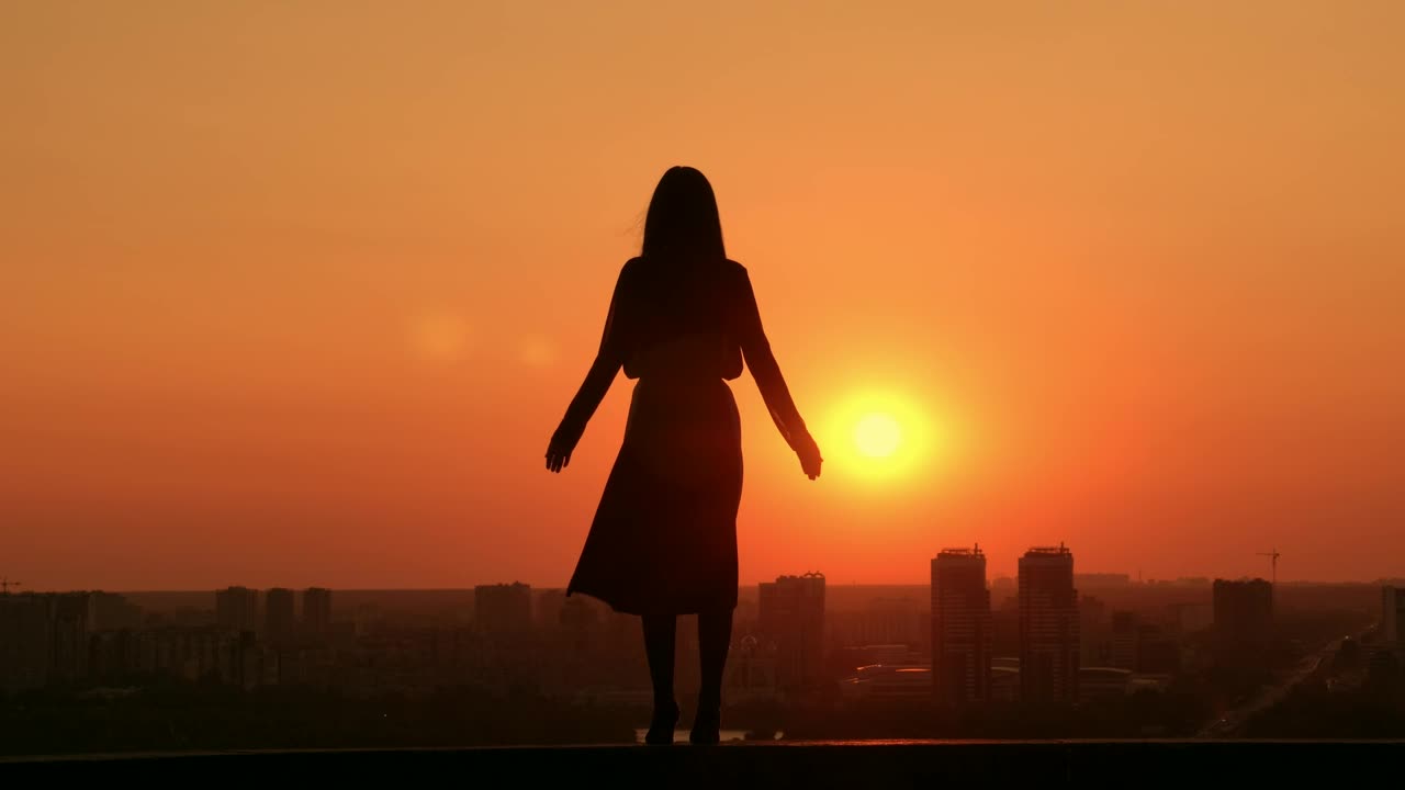 Woman during a sunset on a rooftop