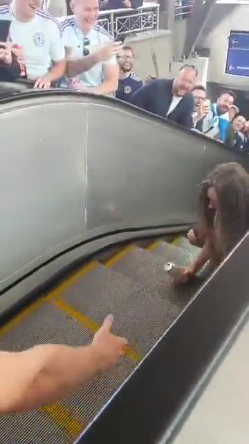 Scottish fan with beer in hand fights for his life on the wrong escalator