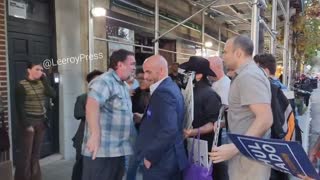 A man chokes a woman protesting outside a Hochul rally