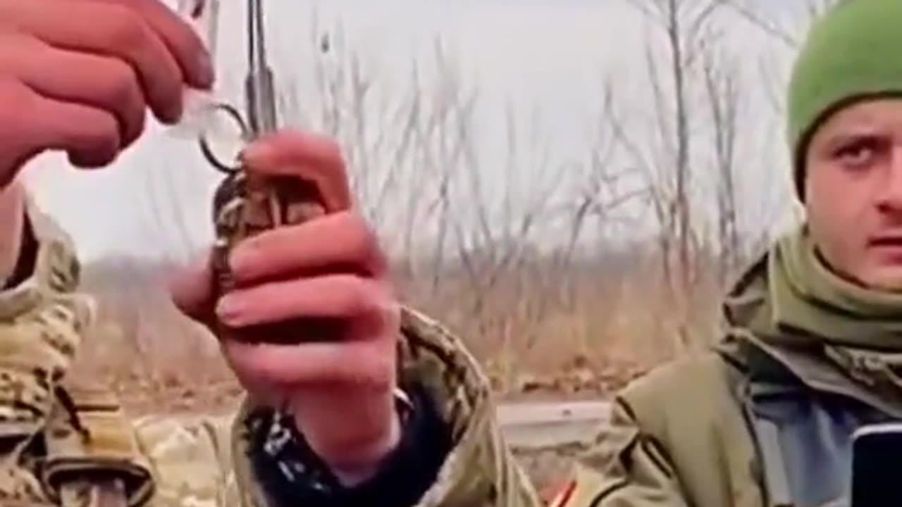 Ukrainian soldier preparing a grenade on the drone