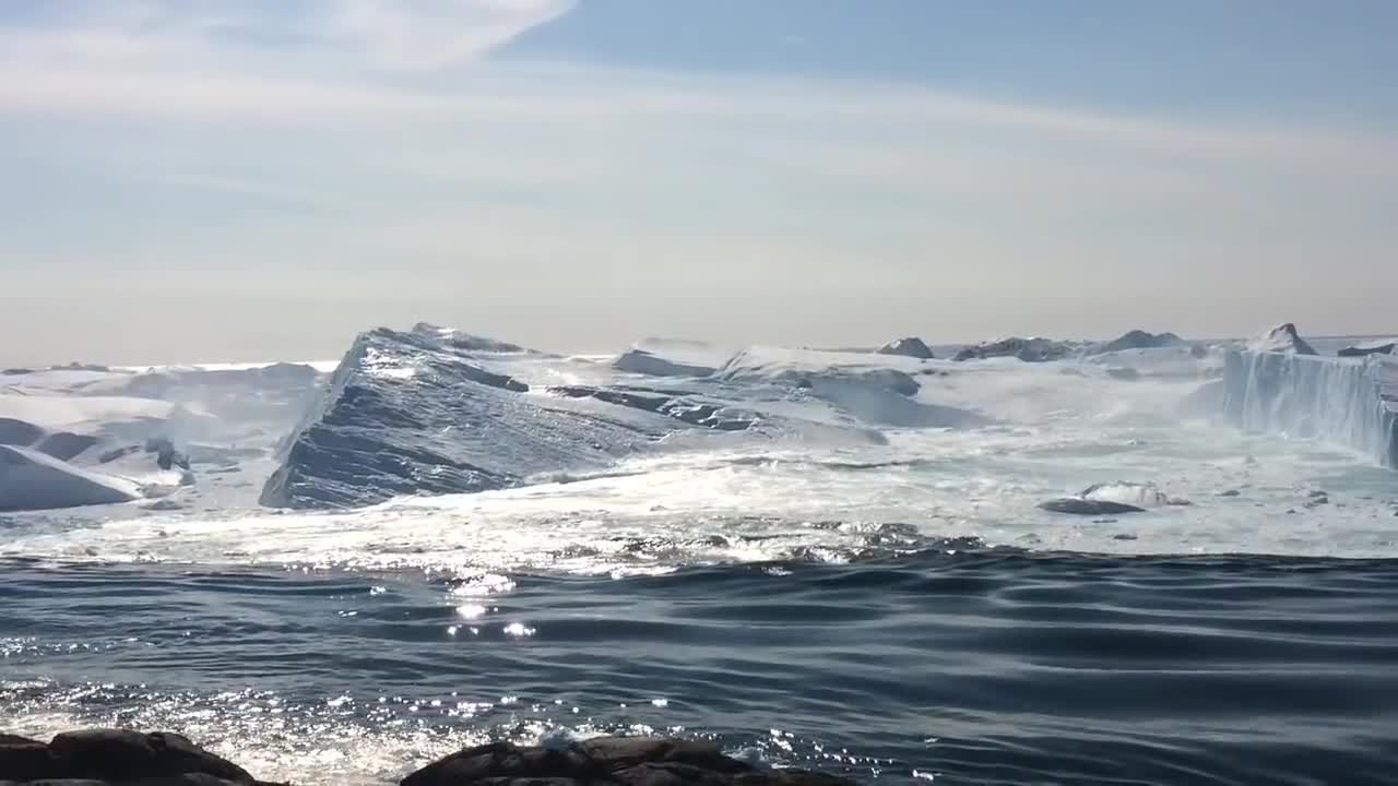 Ilulissat Icefjord - Large iceberg breaking over