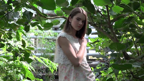 Cute young girl white dress in the jungle