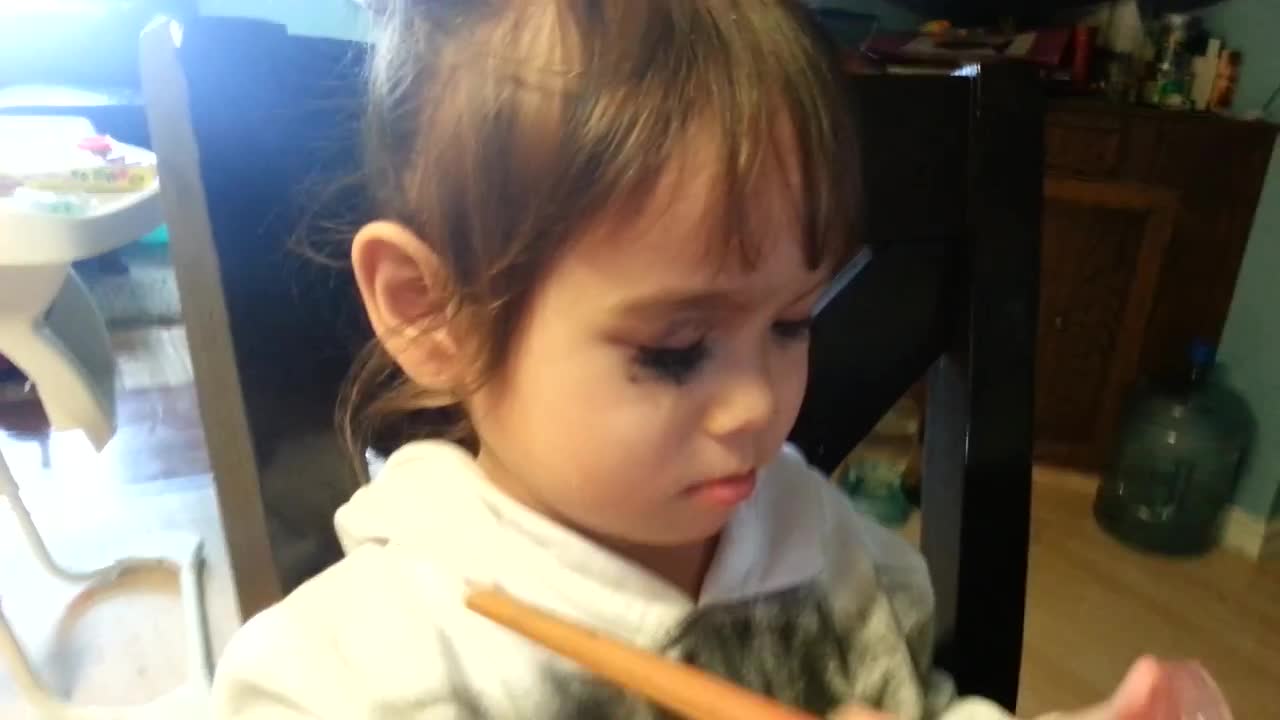 Girl gets caught using mommy's makeup, continues to apply it