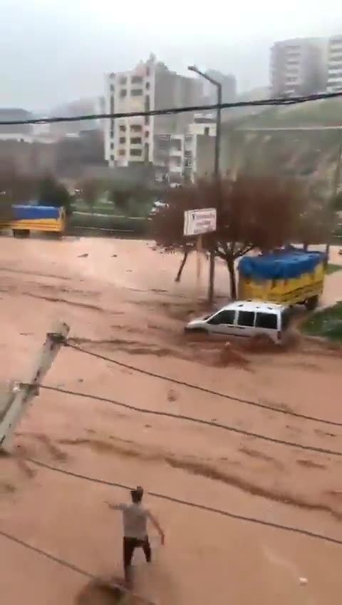 Dramatic video from Turkey shows men reportedly rescuing a mother and her child getting swept away..