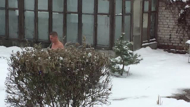 Russian man doused with cold water and dives into the snow in winter t-15