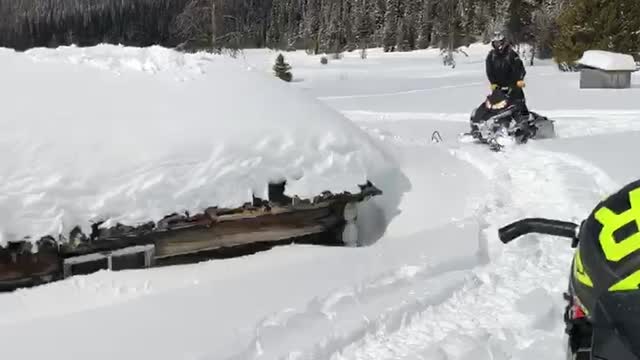 Jumping Snowmobile off Cabin Roof