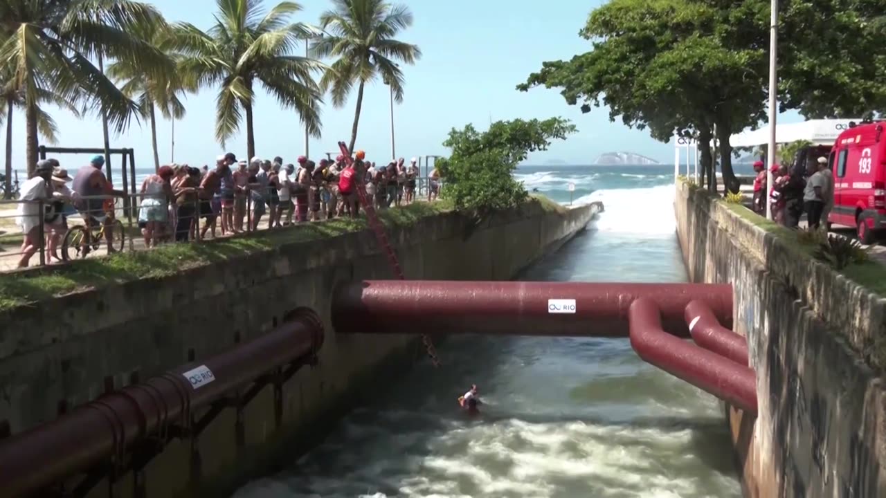 Firefighters in Rio rescue man watching big waves