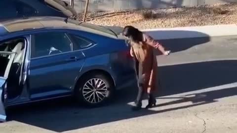 A woman tries to park a car