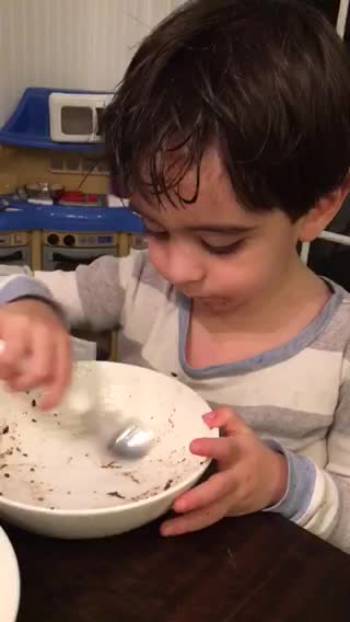 Boy can't get enough chocolate cake and vanilla ice cream
