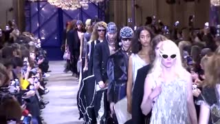 Climate protestor storms Louis Vuitton catwalk