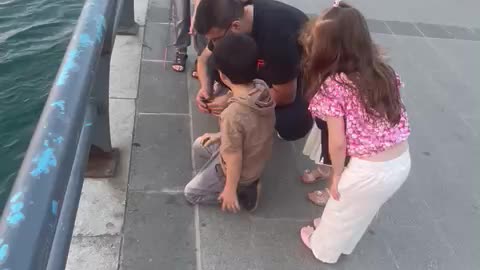 happy children , their father catch a fish