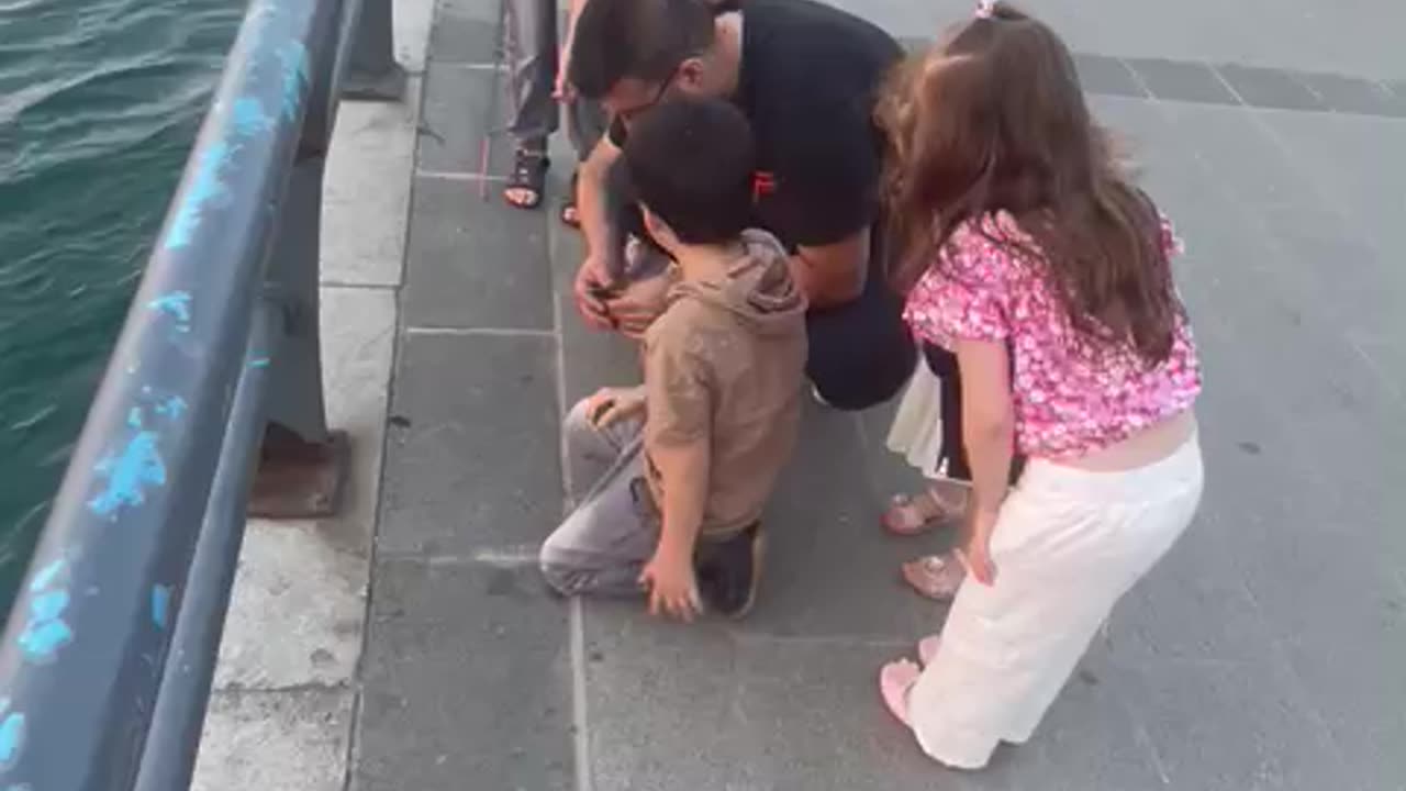 happy children , their father catch a fish