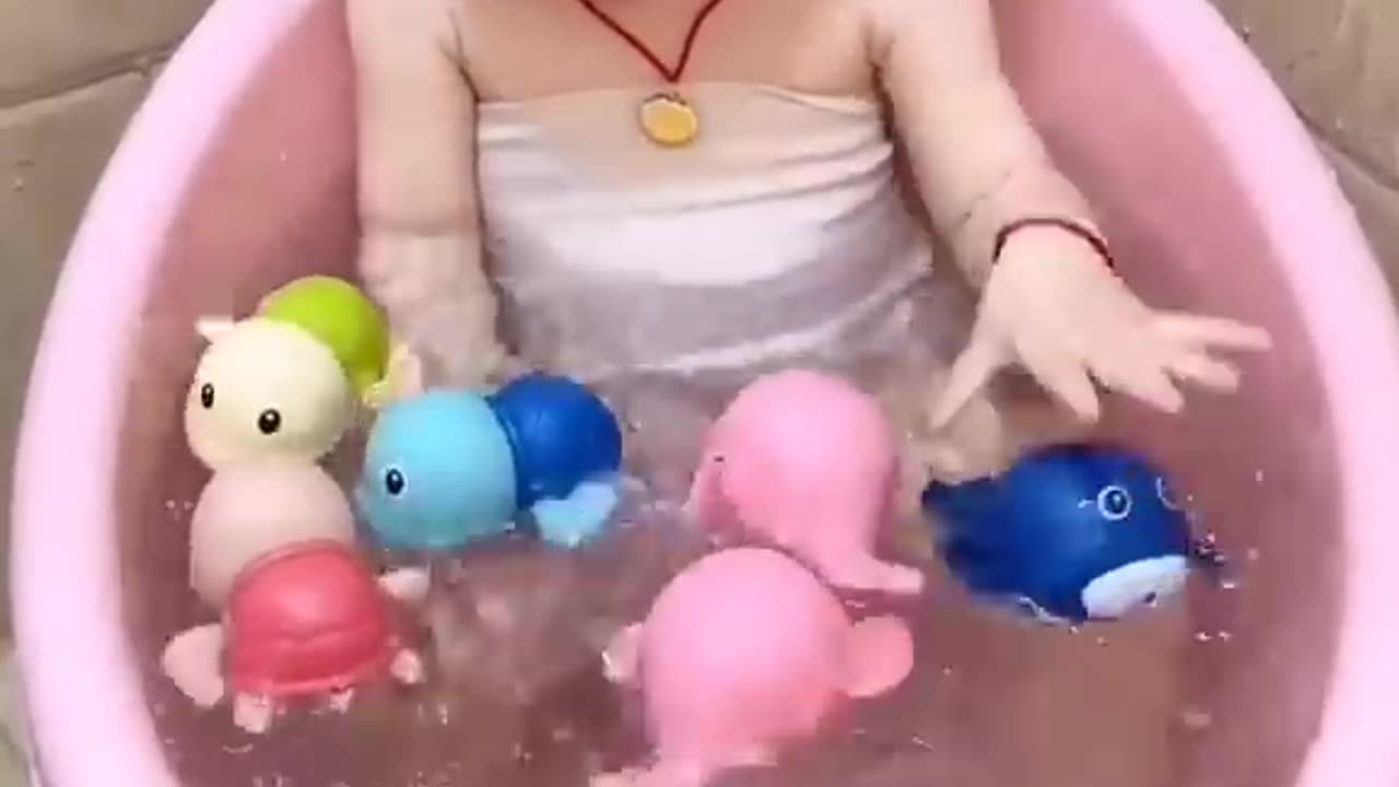 Cute baby playing with fishes