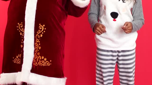 Young Girl and Santa Claus Dancing