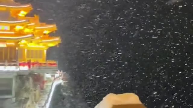 An entry view of a Chinese temple in the mountains during a storm