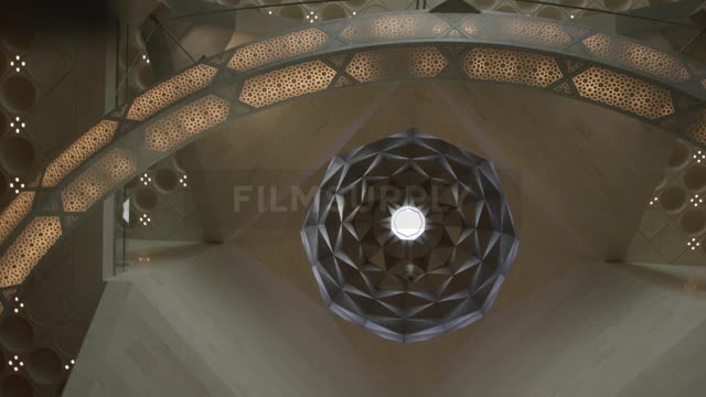 An ornate honeycomb chandelier hangs from the ceiling