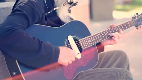 Street Artist Singing and Playing Guitar