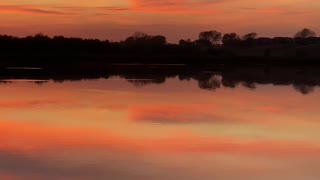 A Lake Mirrors a Sunset