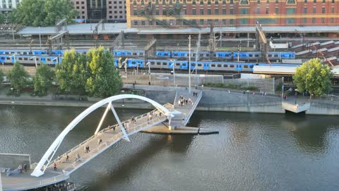 Melbourne Australia foot bridge and passing train