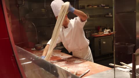 A man making noodles in the kitchen at Caesars palace in Las Vegas.