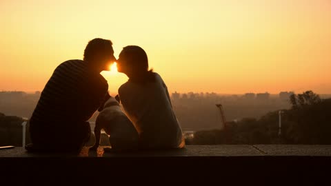 A couple in love watching a romantic sunset