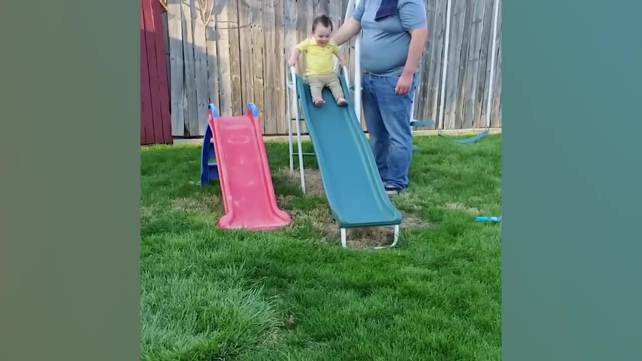 Funny babies playing slide