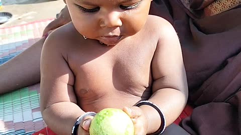 Enjoying with kids he is eating gwava without teeth
