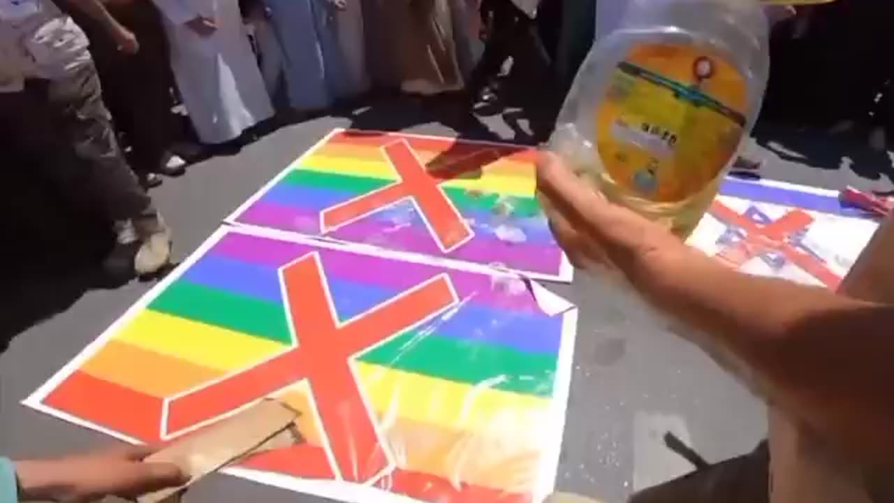 Muslims in Iraq burned the LGBT flag in retaliation for Sweden's burning of the Quran.