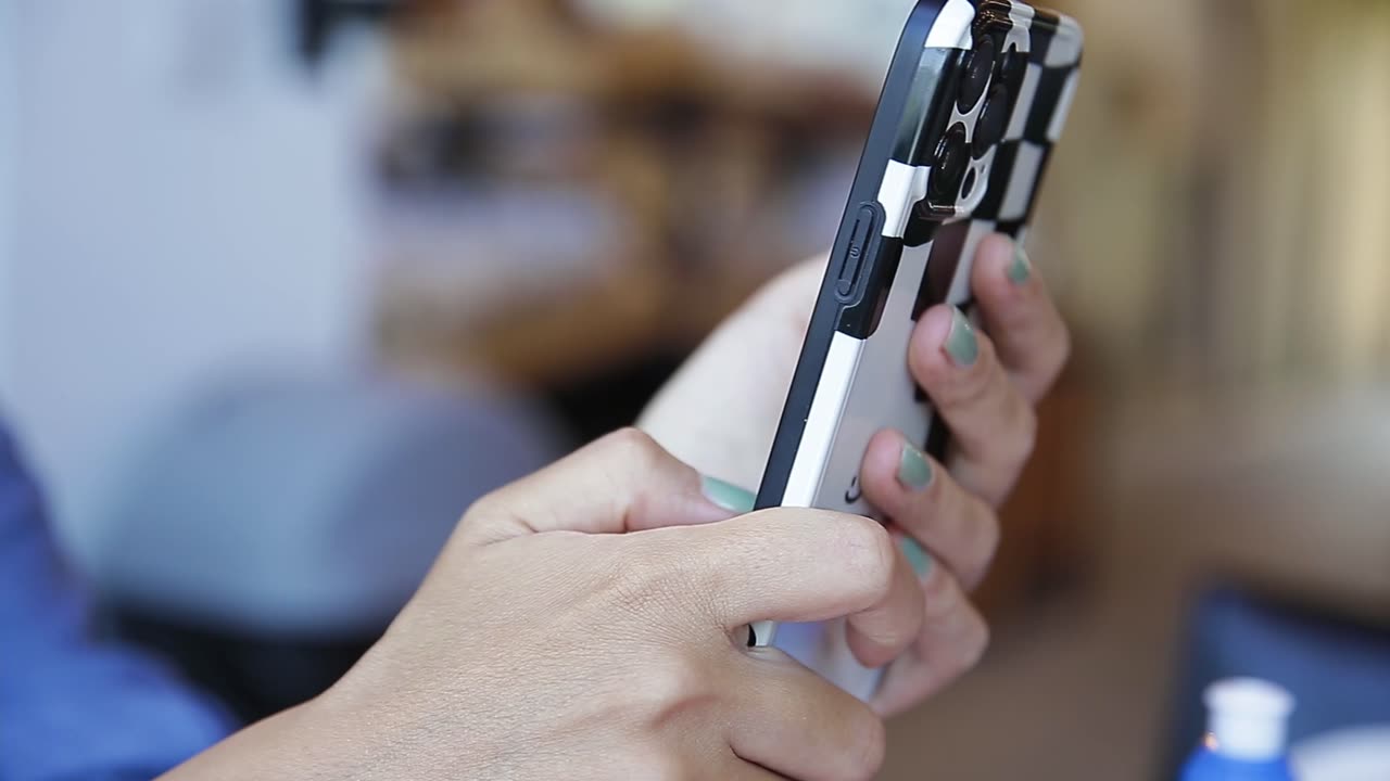 the hand of a woman using a smartphone